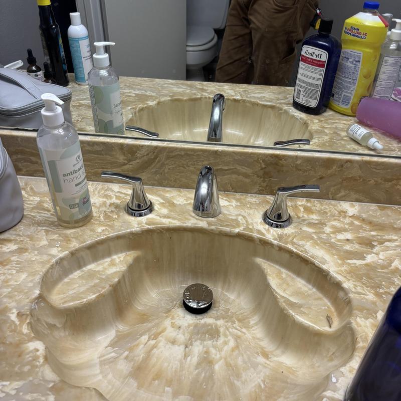 Bathroom faucet with marble countertop and hand soap