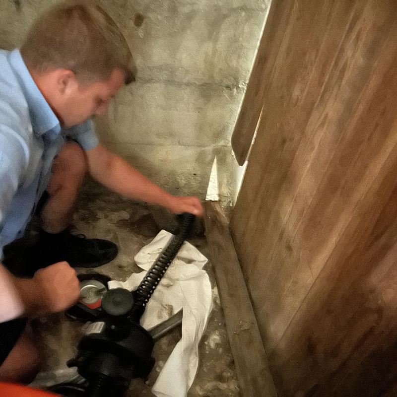 Drain cleaning auger in basement corner