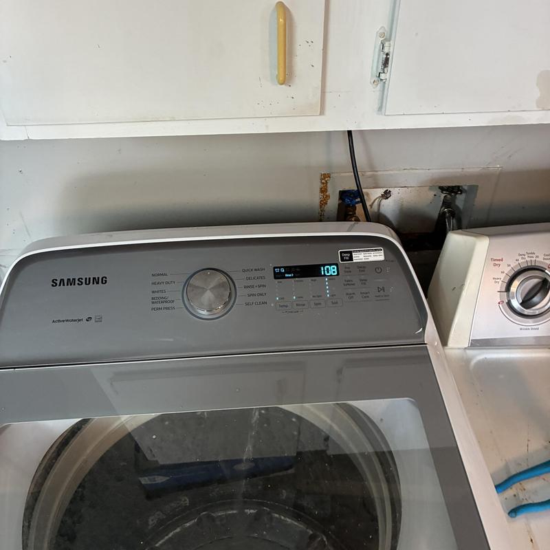 Laundry drain pipe behind Samsung washing machine