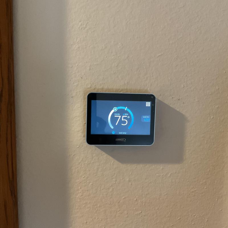 Lennox digital thermostat on beige wall