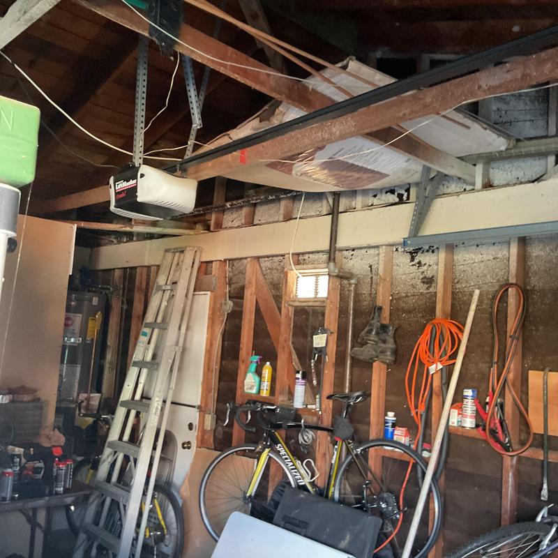 Garage ceiling with exposed beams and storage items