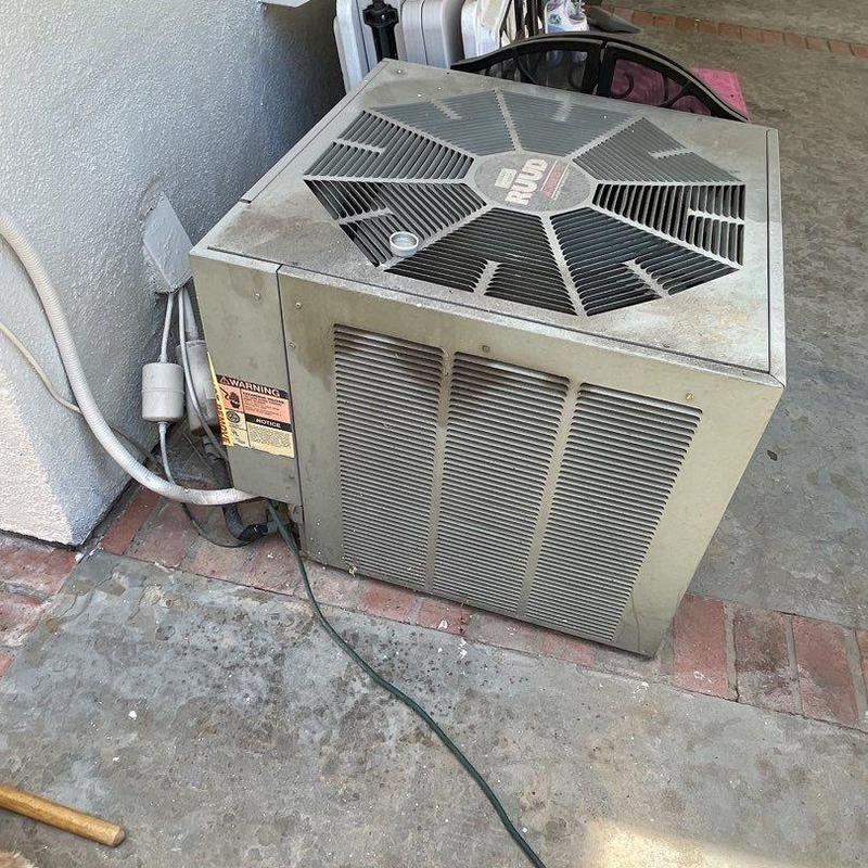 Ruud air conditioner condenser unit on concrete floor