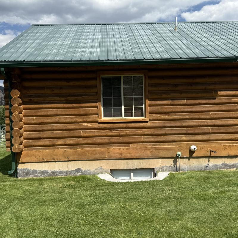 Gutter installation on log home with metal roof Gutter installation on log home with metal roof