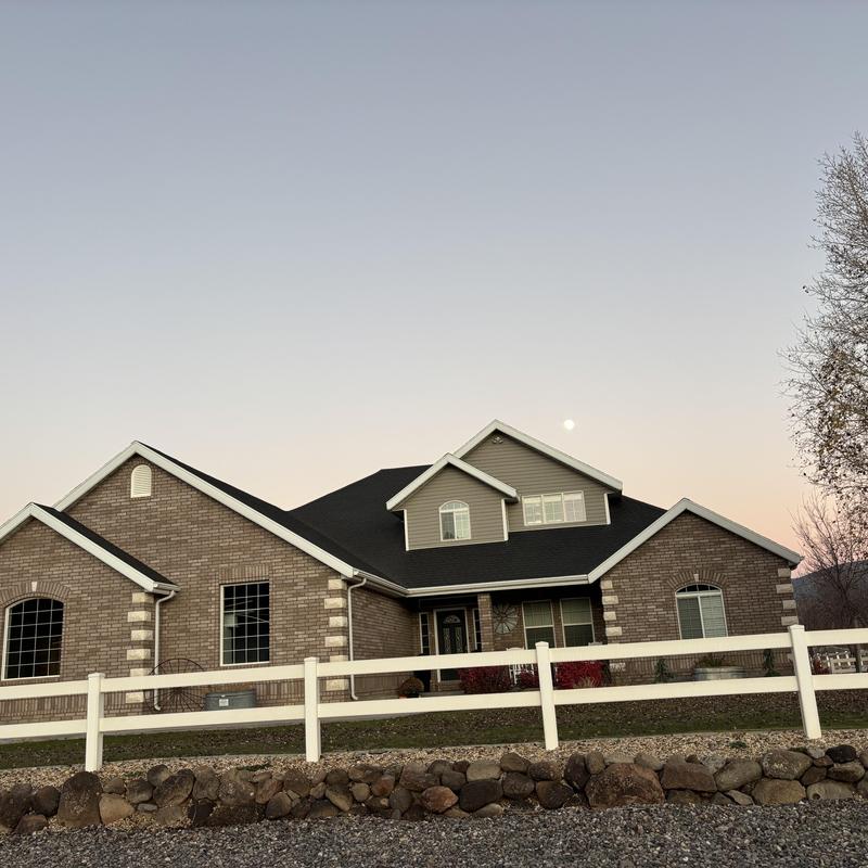 Asphalt shingle roof with moonlit sky at dusk