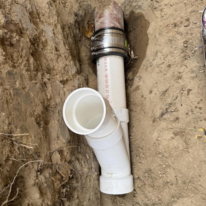 4-inch PVC sewer pipe with cleanout and clamps