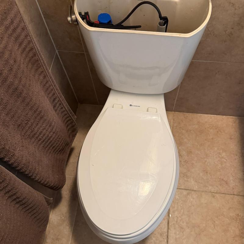 Toilet tank replacement with bolts tightened and leak tested