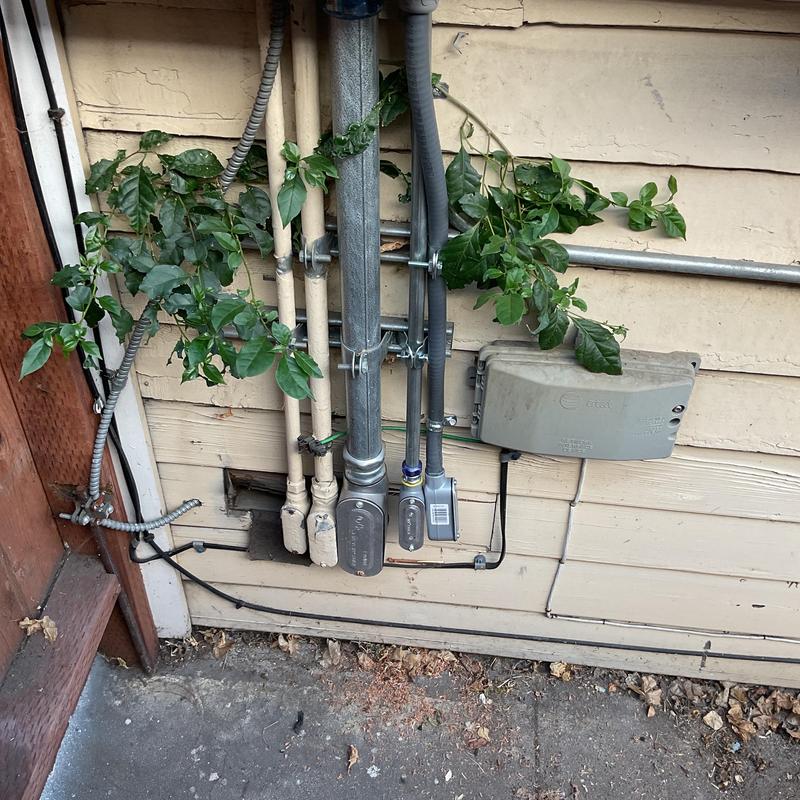Electrical conduits and communication box on exterior wall