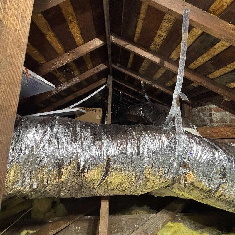 Ductwork installation in attic with metal straps