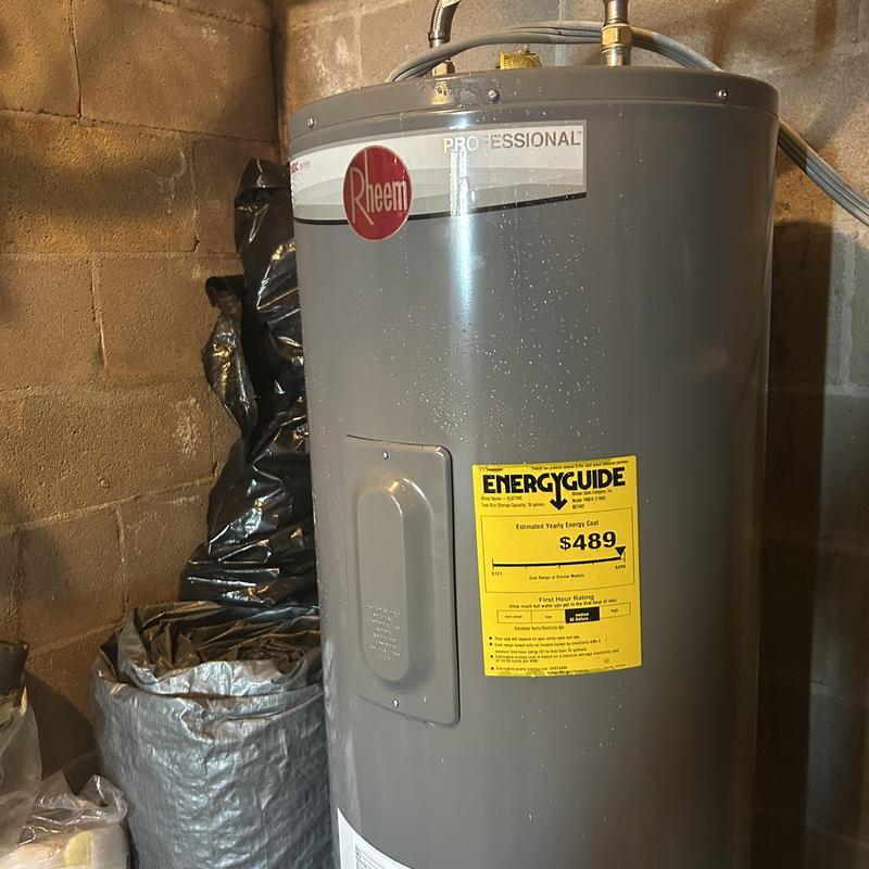 Water heater with EnergyGuide label in basement
