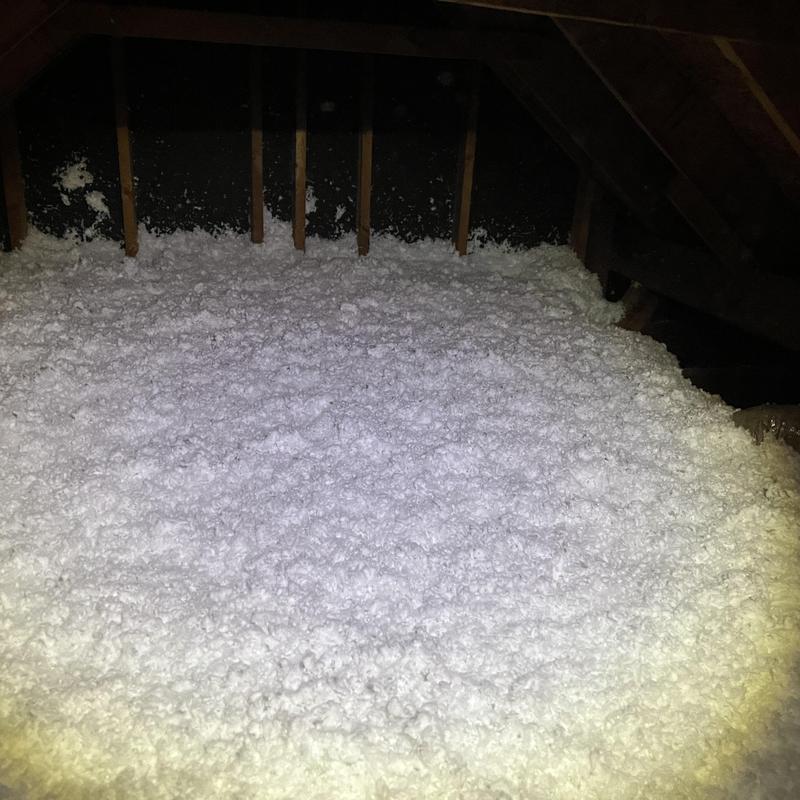Attic loose-fill insulation covering floor joists