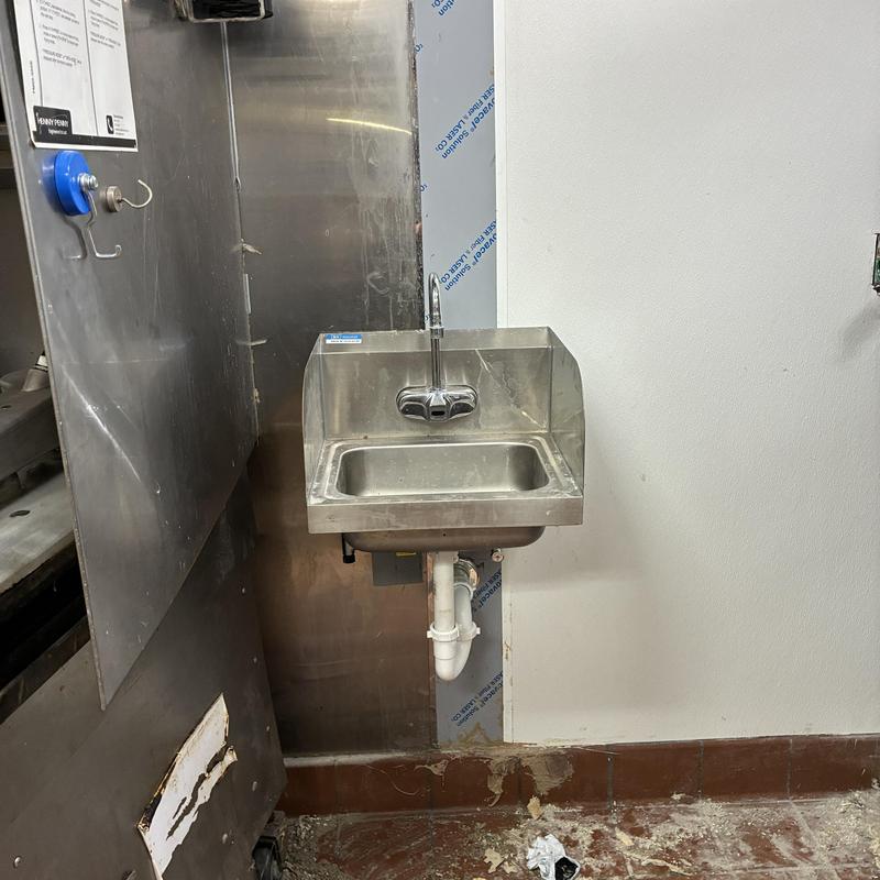 Hand sink installation with adjacent empty space