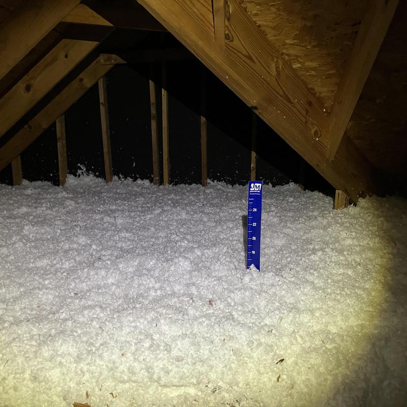 Attic cellulose insulation with depth measurement ruler