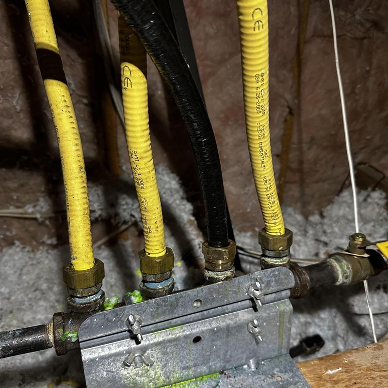 CSST gas piping manifold with yellow corrugated tubing