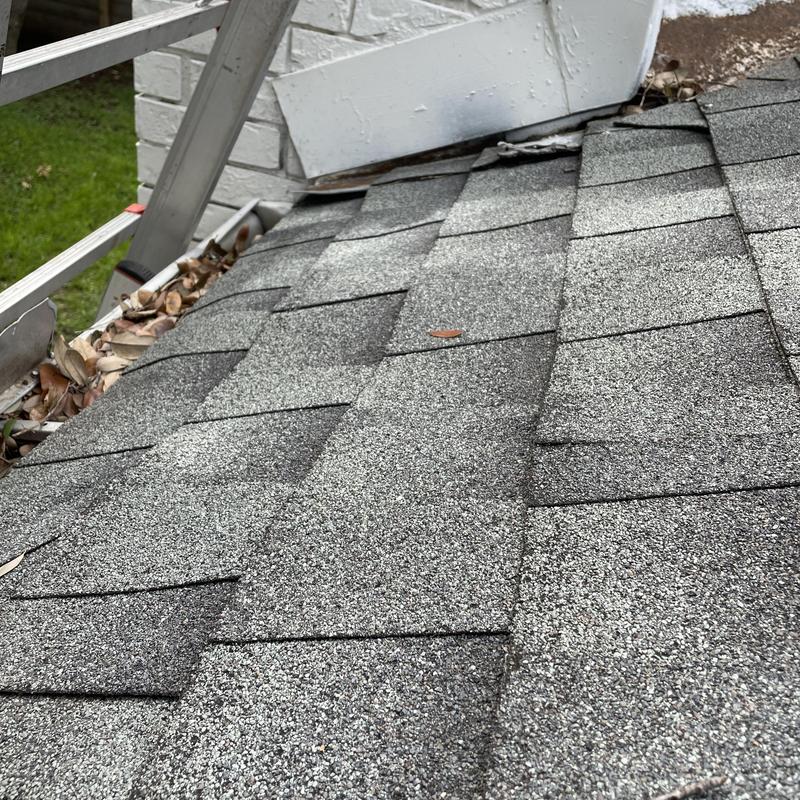Roof shingles with chimney flashing separation damage