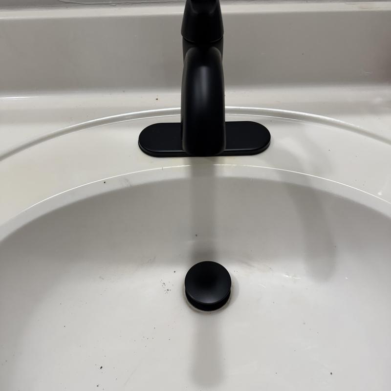 Vanity faucet installation with black lever handle