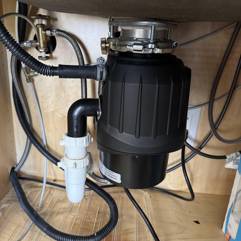 Garbage disposal unit installed under kitchen sink
