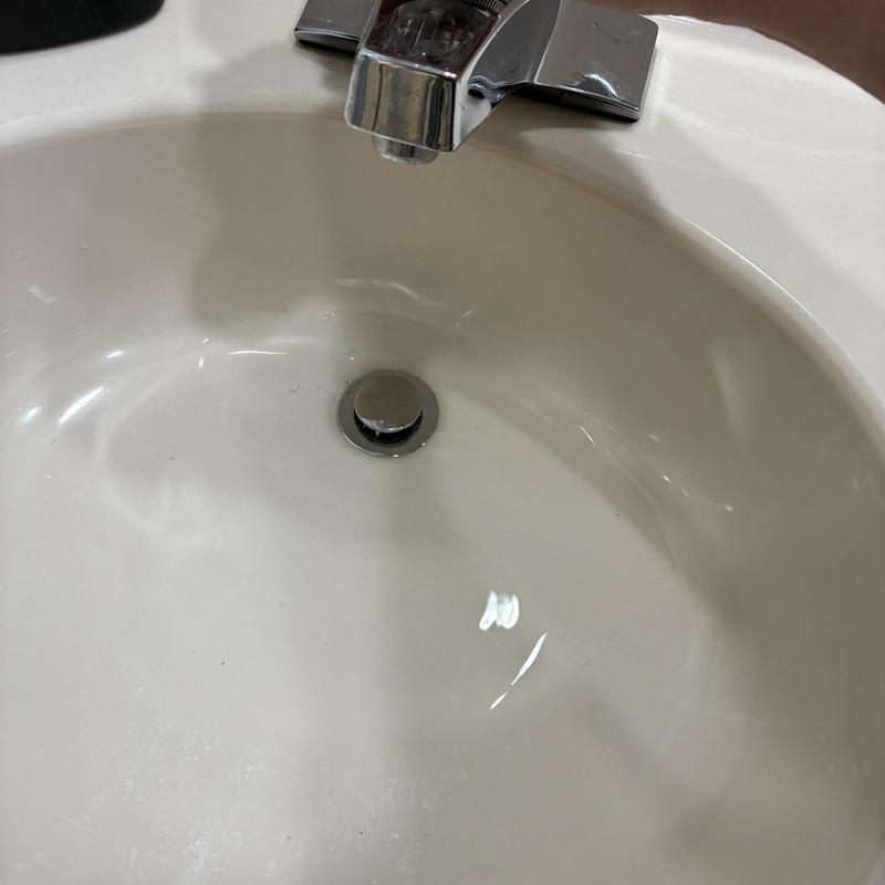 Lavatory sink drain with water flow and stopper