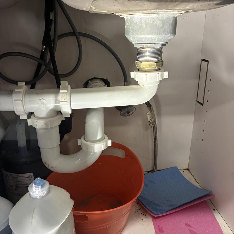 Sink drain pipes with bucket placed underneath