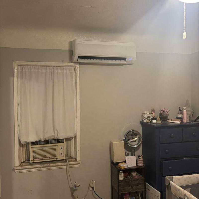 Mini split AC unit installed above window air conditioner Mini split AC unit installed above window air conditioner