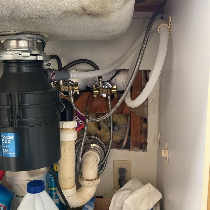 Dishwasher drain and water supply lines installed under sink
