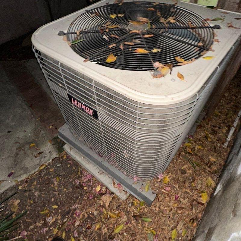 Lennox ML14KC1 condenser unit outdoors with leaves