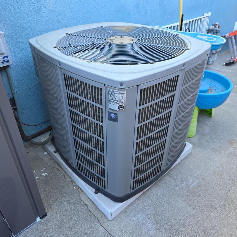 ML14KC1 condenser unit on concrete pad outdoors