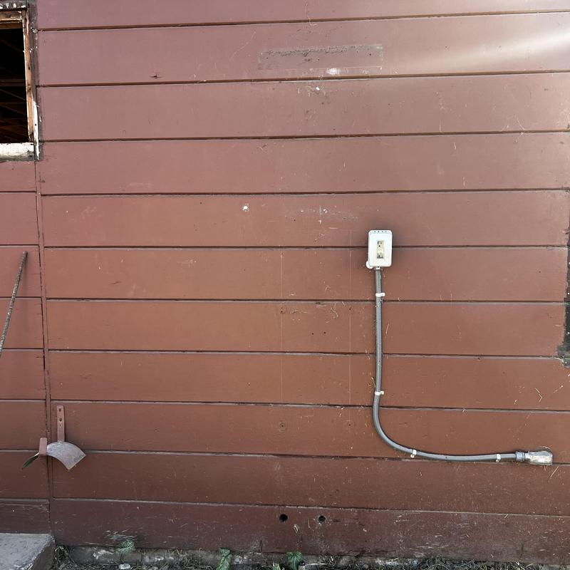 Tankless water heater removal site, exposed wall panel