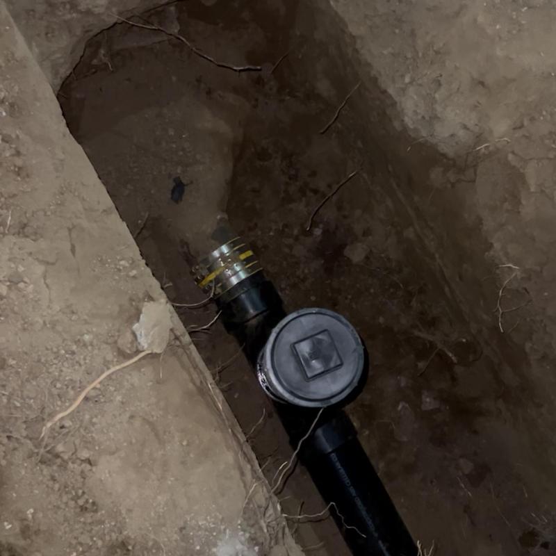 Sewer pipe and cleanout in excavated trench