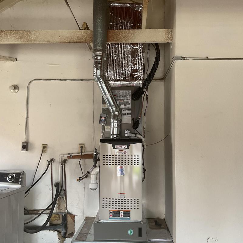Furnace unit with duct venting installed in laundry room