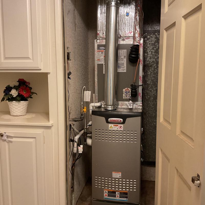 Lennox EL180UH furnace with vent pipe in closet