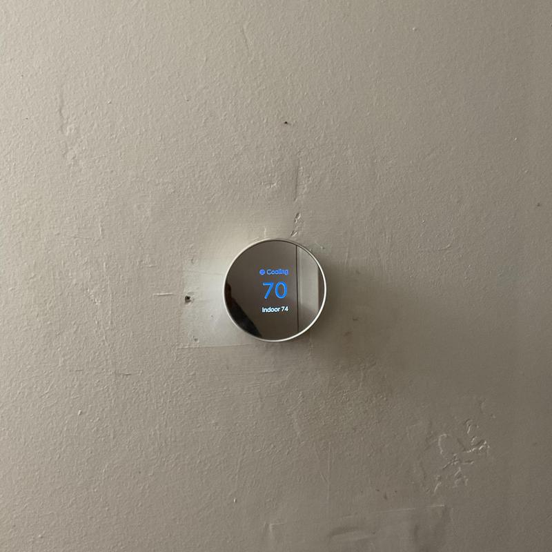 Smart thermostat displaying cooling at 70 degrees