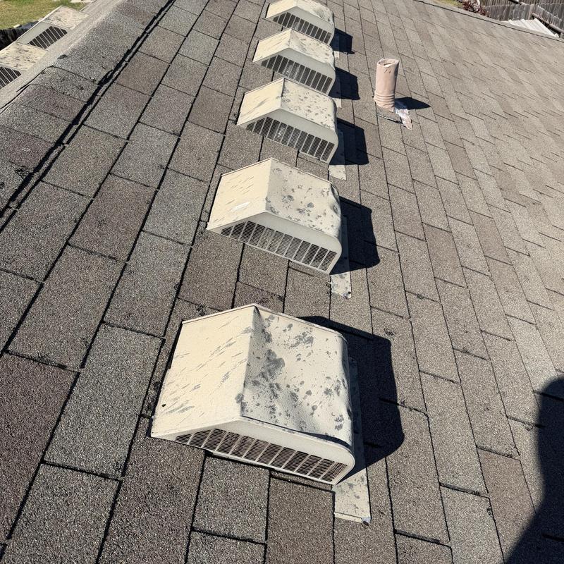 Roof shingles with hail damage and vent covers
