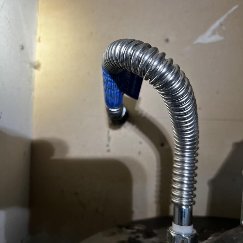 Water heater flexible connector installation close-up