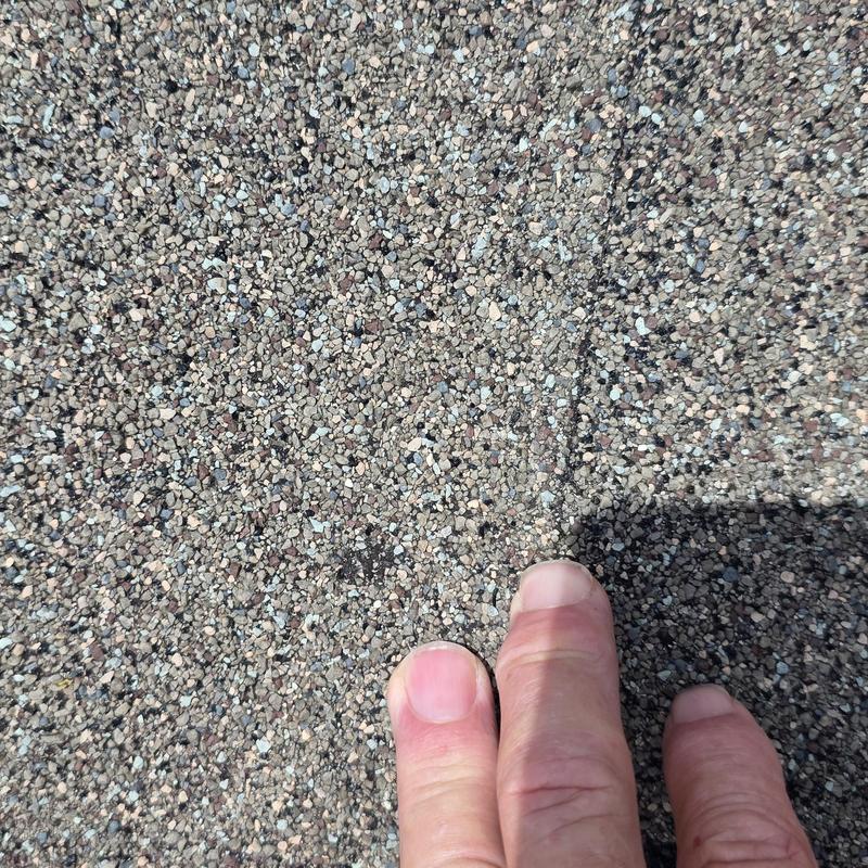 Asphalt shingle roof with hail impact damage close-up