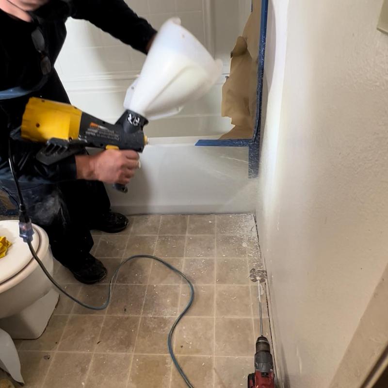 Right hand tub spray painting during installation in bathroom