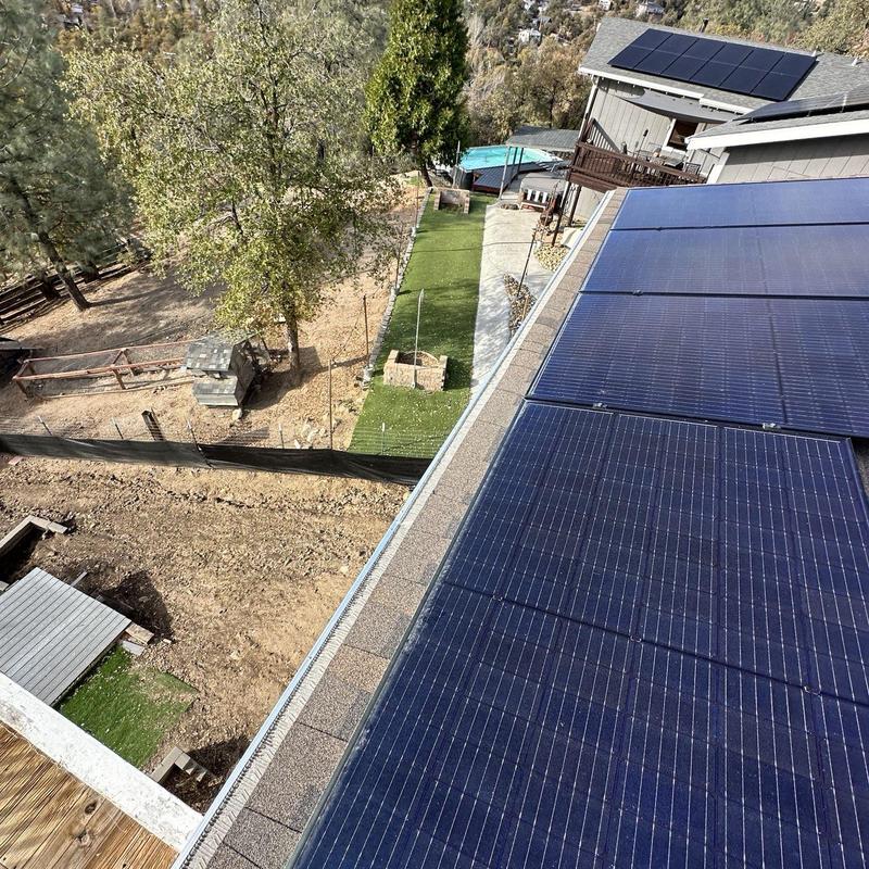 Solar panels installation on rooftop with yard view Solar panels installation on rooftop with yard view