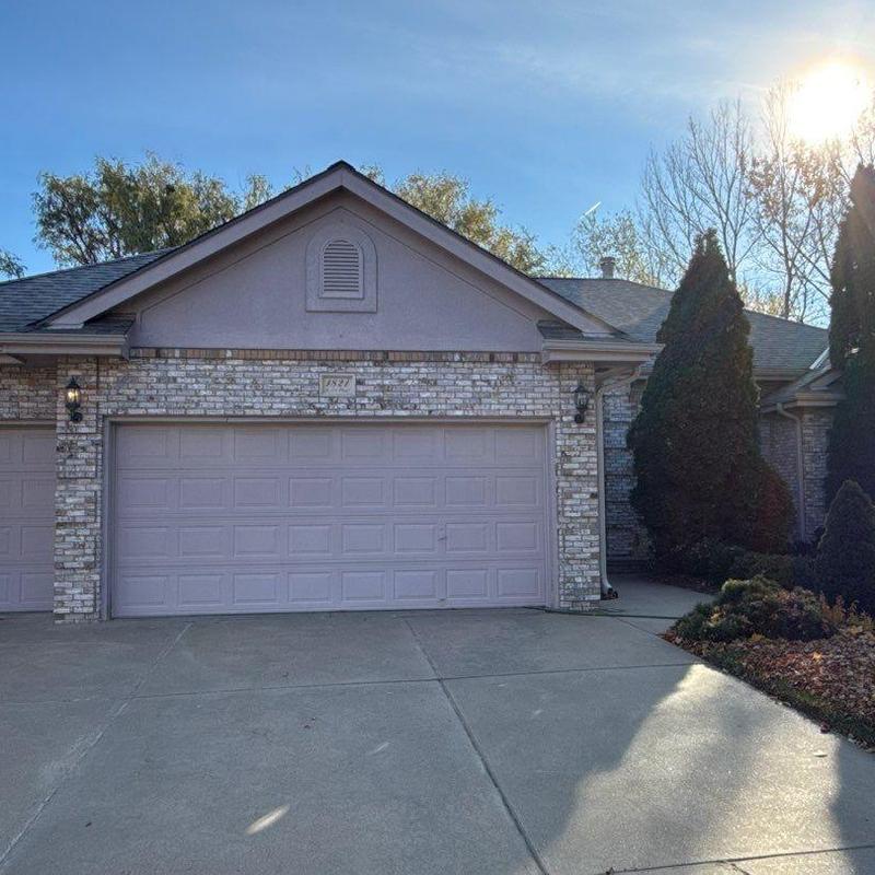 Garage door exterior with brick facade and driveway