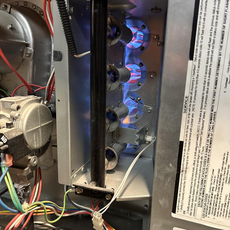 Gas furnace burners with blue flame during maintenance