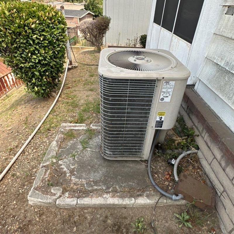 ML14KC1 condenser unit on concrete pad outdoors