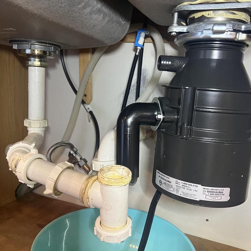 Garbage disposal and kitchen sink drain piping under cabinet