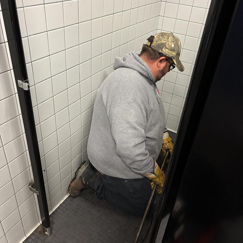 Branch main drain cleaning in restroom stall