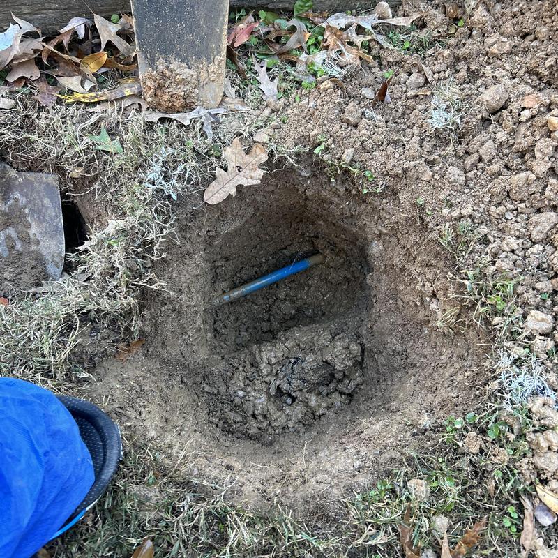 Water service pipe leak excavation in yard dirt