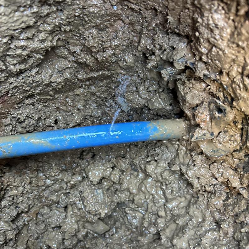 Water service pipe leaking with muddy surroundings