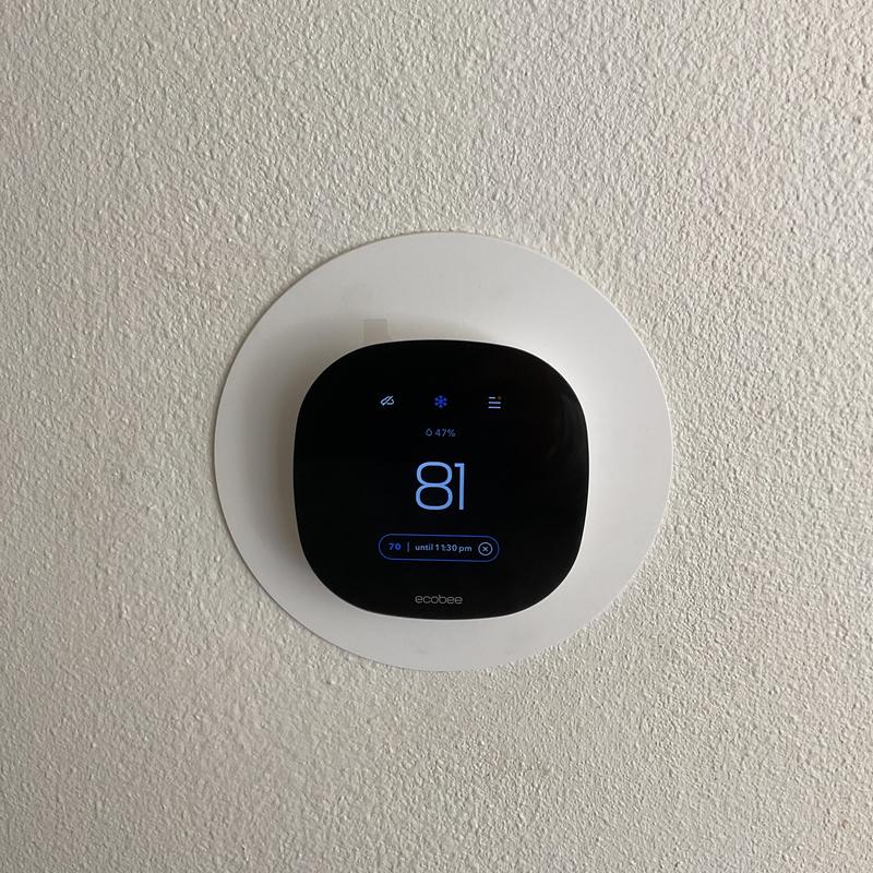 Ecobee thermostat on wall showing temperature 81°F