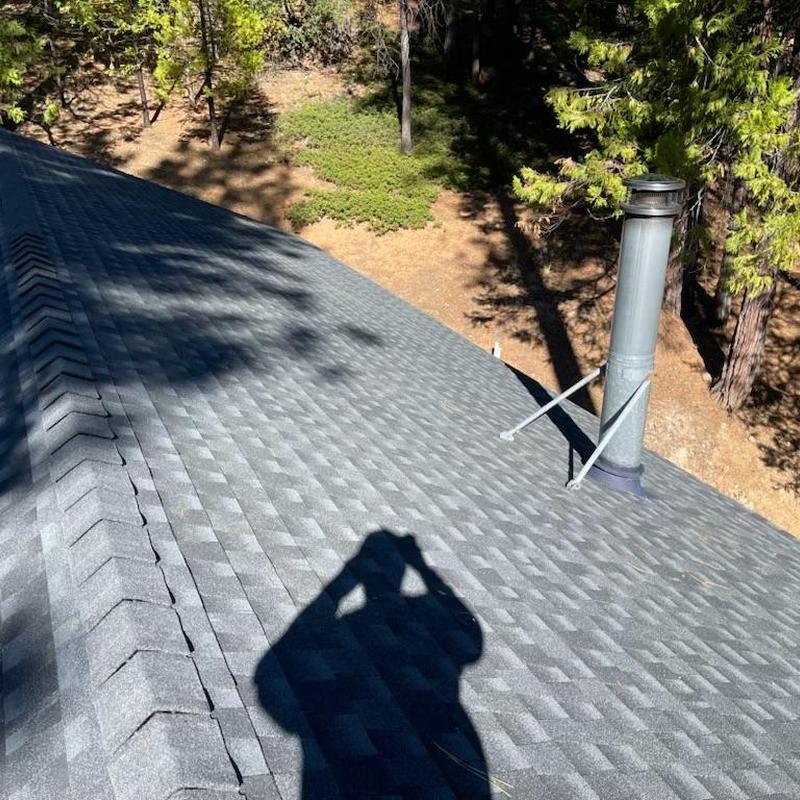 GAF Lifetime asphalt roof with chimney pipe in forest