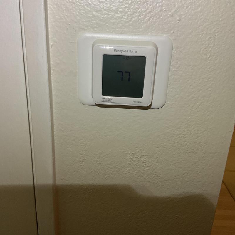 Honeywell Home thermostat display set to 77 degrees Honeywell Home thermostat display set to 77 degrees