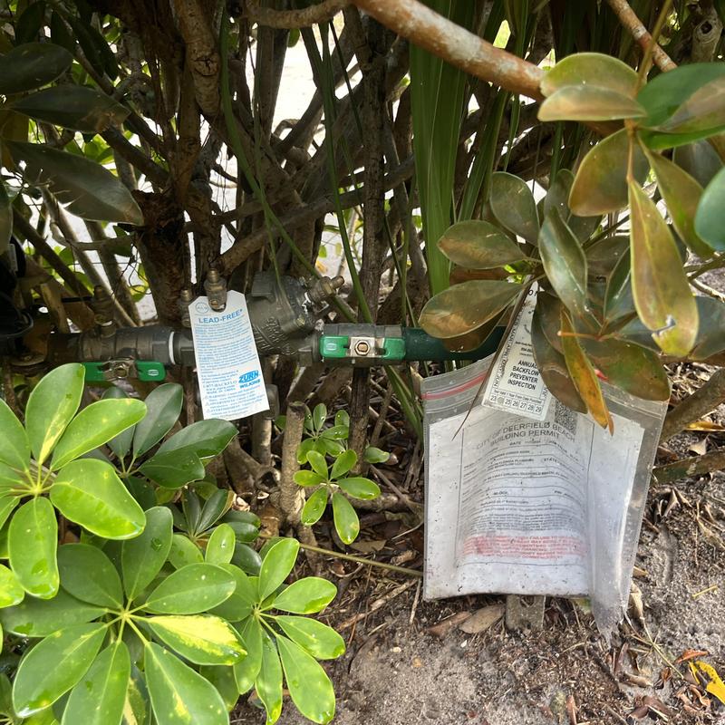 Backflow prevention valves with inspection tags outdoors