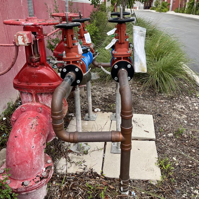 Backflow valve system with copper pipe rerouting