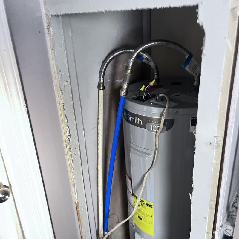 Water heater with flexible hose and piping connections