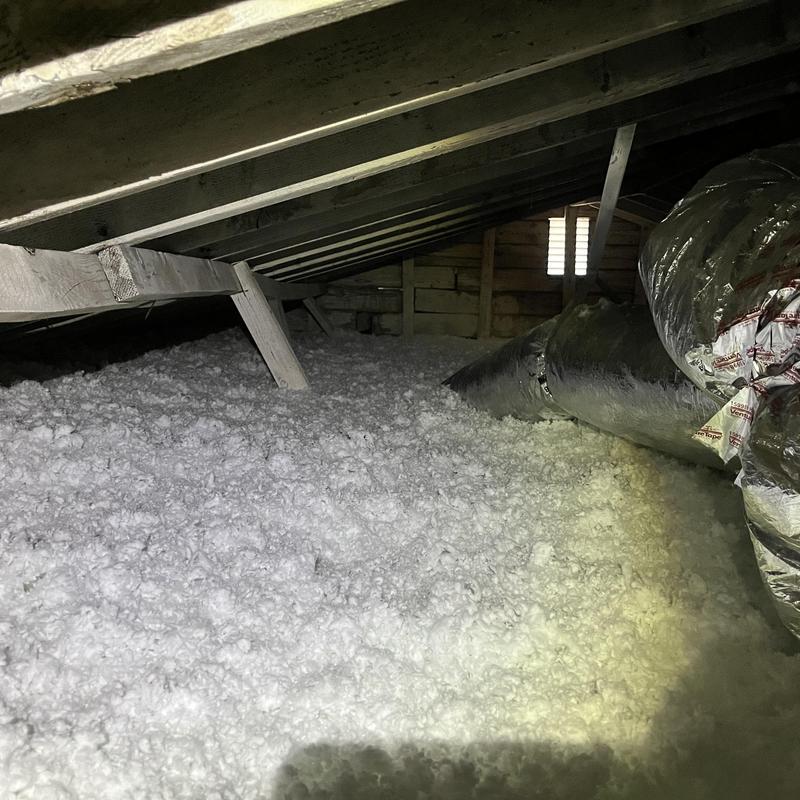 Attic insulation with ductwork and wooden rafters